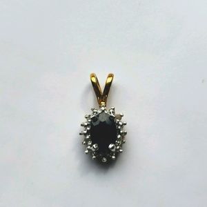 Gold oval pendant with gemstones